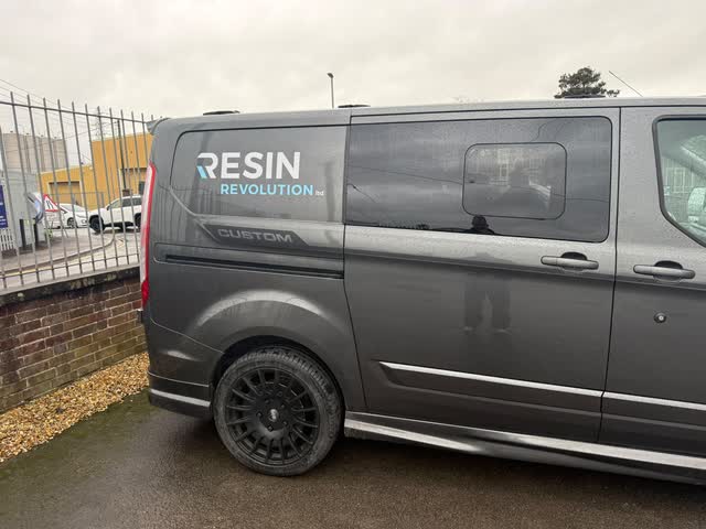Grey Resin Revolution van with the company branding on its side
